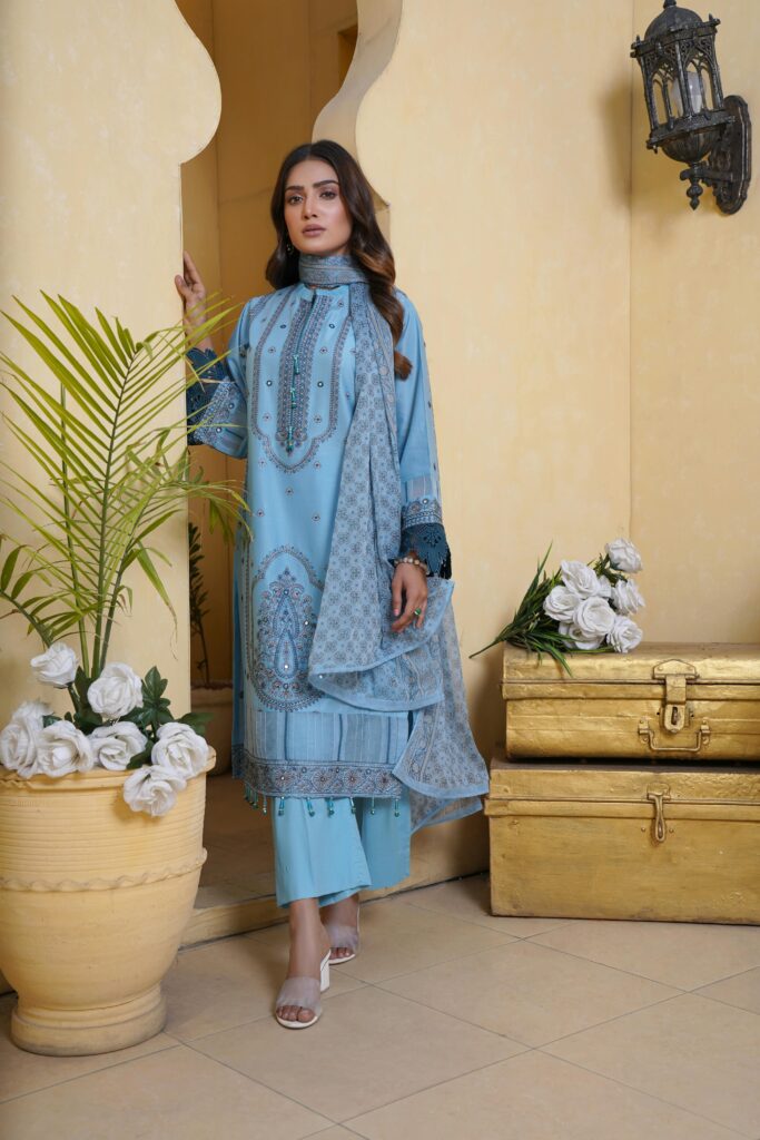 Fashion model in embroidered blue salwar kameez posing in Lahore, Pakistan.